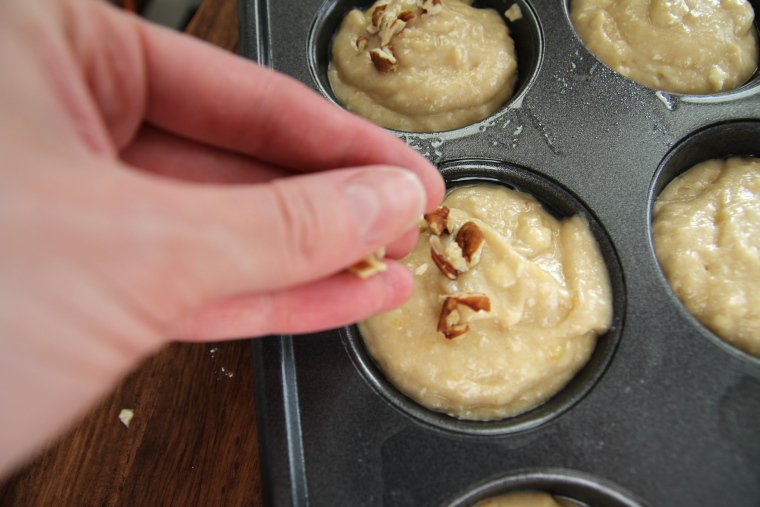 sprinkling nuts on muffin batter