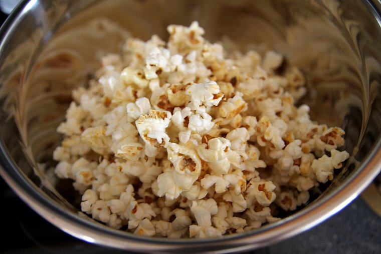 Pour popcorn into a large bowl