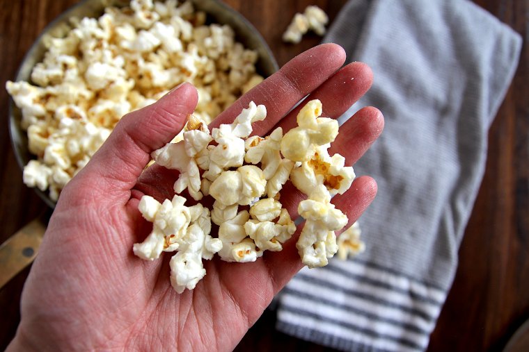 Hand holding homemade kettle corn