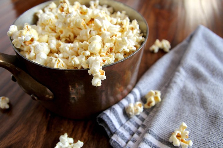 side view of kettle corn popcorn in a copper pan