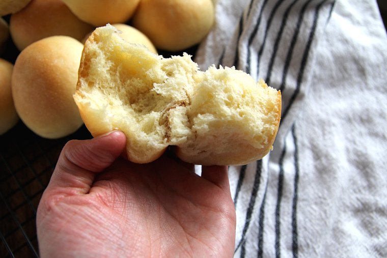 a sourdough potato roll torn in half