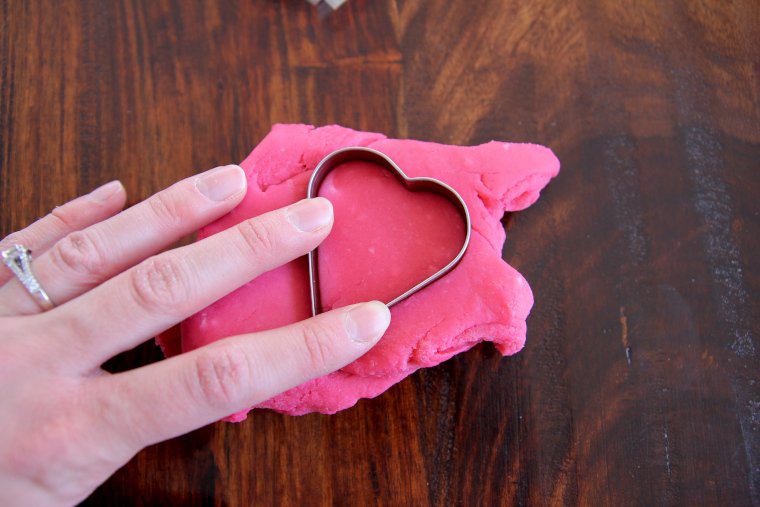 shape playdough with a heart cookie cutter