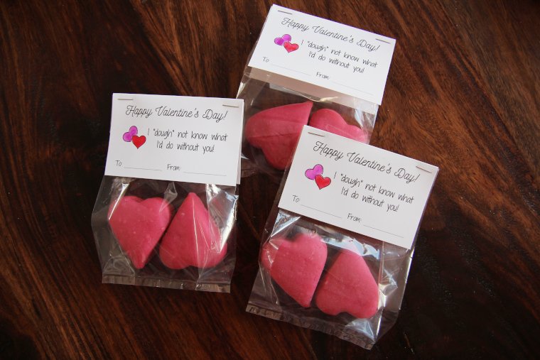 punny playdough valentines for kids sitting on a table