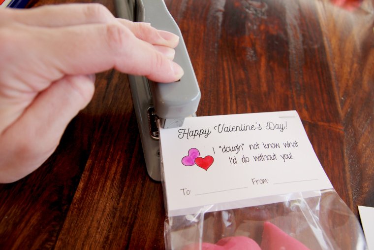 place valentine over treat bag and staple into place in the top two corners
