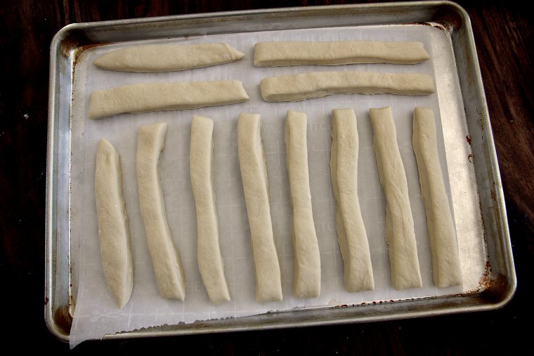 arrange breadsticks on a parchment-lined half sheet pan leaving space between each one