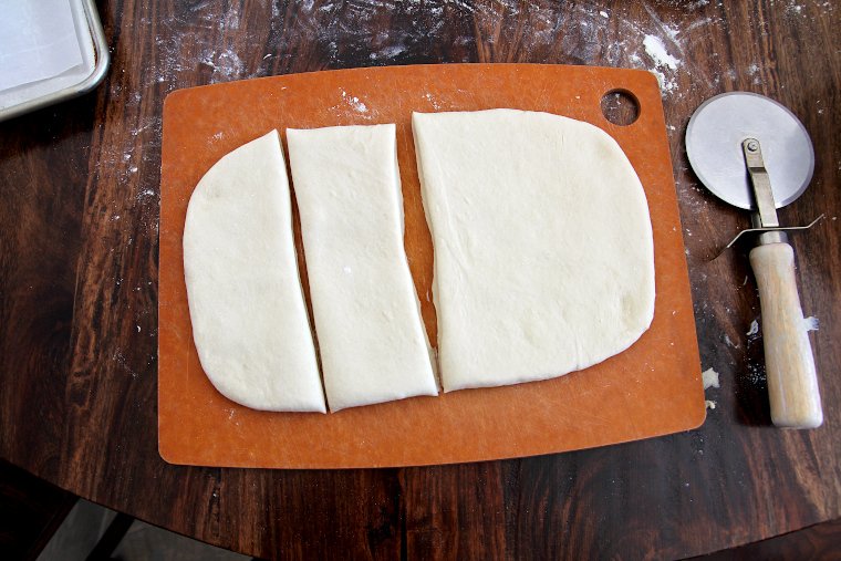 cut dough in half length-wise, and then into quarters