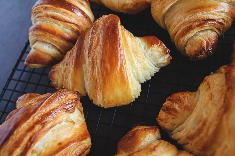 sourdough croissants up close on a cooling rack