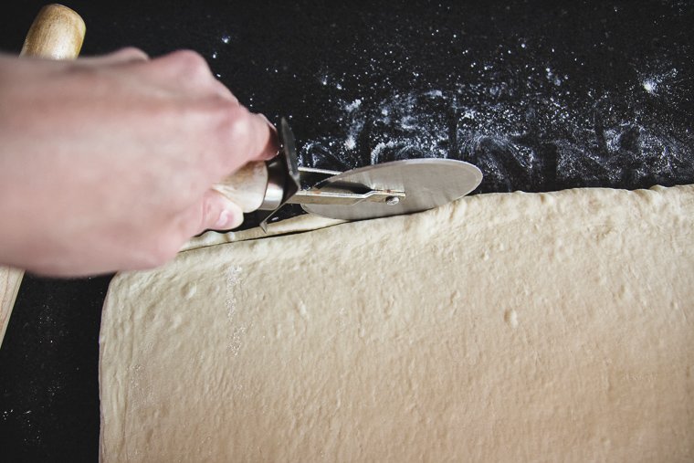 trimming the edges of the rectangle with a pizza cutter