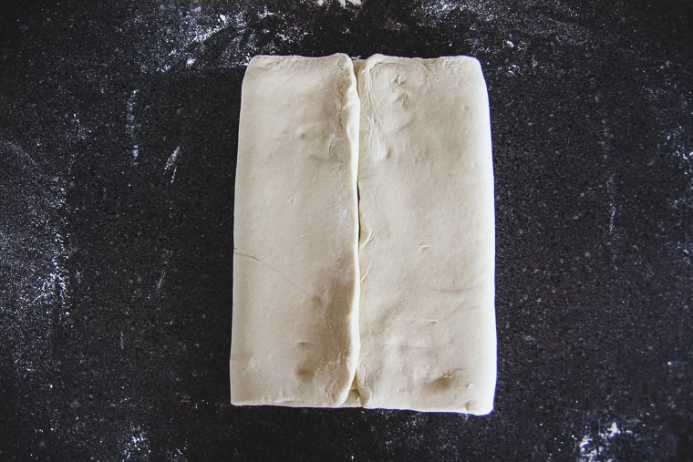 folding the other side of the dough over the butter block to meet in the center with the first side