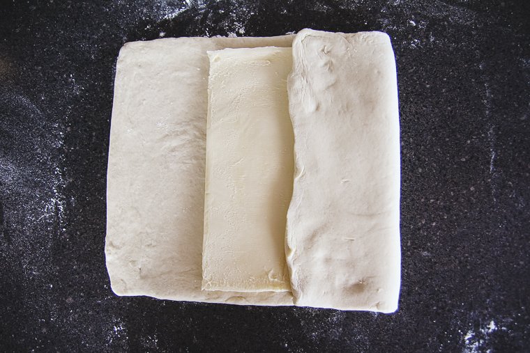 folding one side of the dough over the butter block