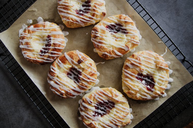 homemade sourdough danish pastries on a parchment-lined cooling rack