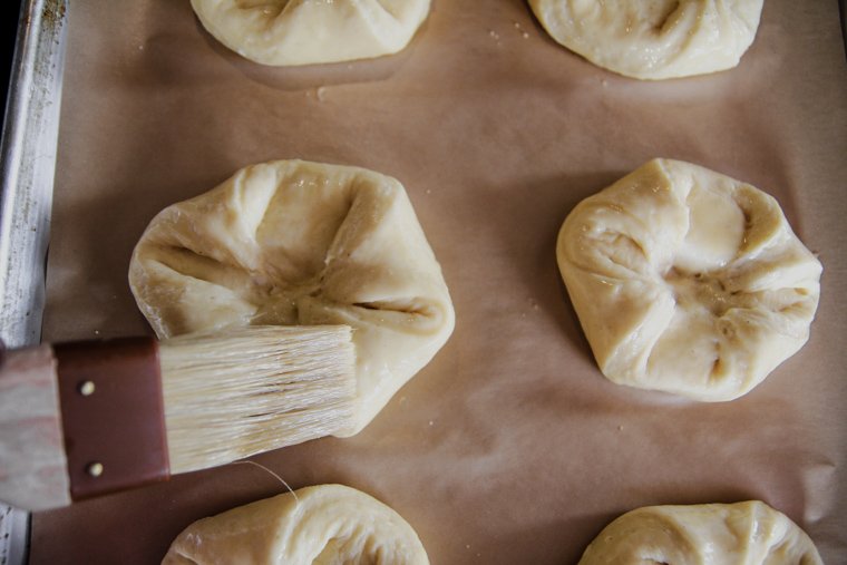 brushing the sourdough pastries with egg wash