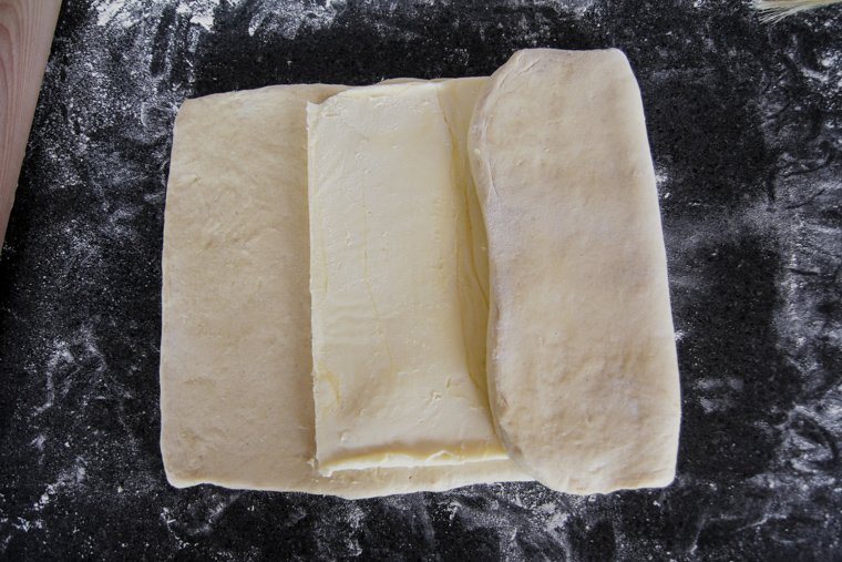 folding the ends of the dough to the center of the butter block