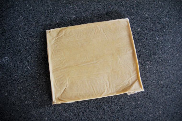 butter pressed into the parchment paper rectangle - the finished butter block