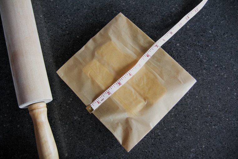 measuring parchment paper to crease it in an 8"x7" rectangle over butter