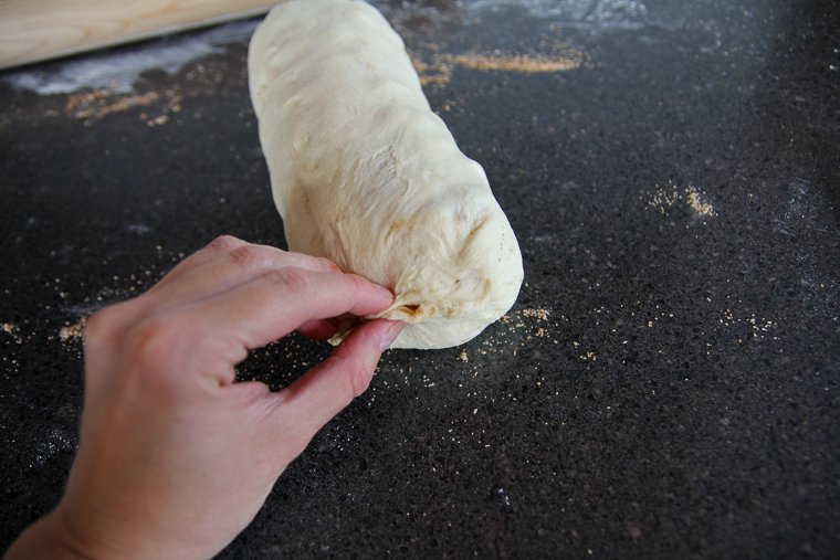 pinching the ends of the loaf closed