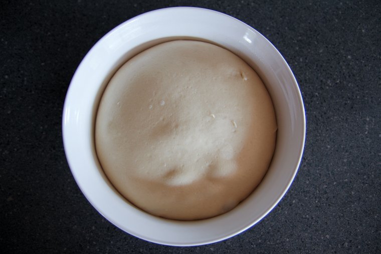 sourdough cinnamon raisin bread dough filling the bowl after fermentation