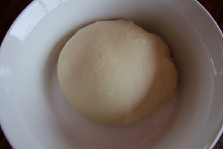 dough after forming into a ball and placing in a bowl