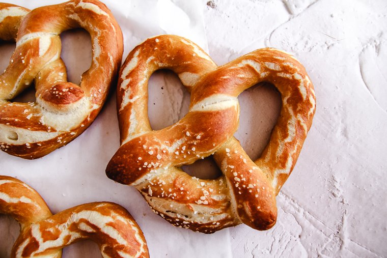 a close up shot of a salted sourdough soft pretzel