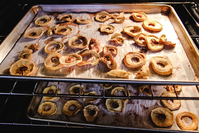 two trays of apples dehydrating in the oven