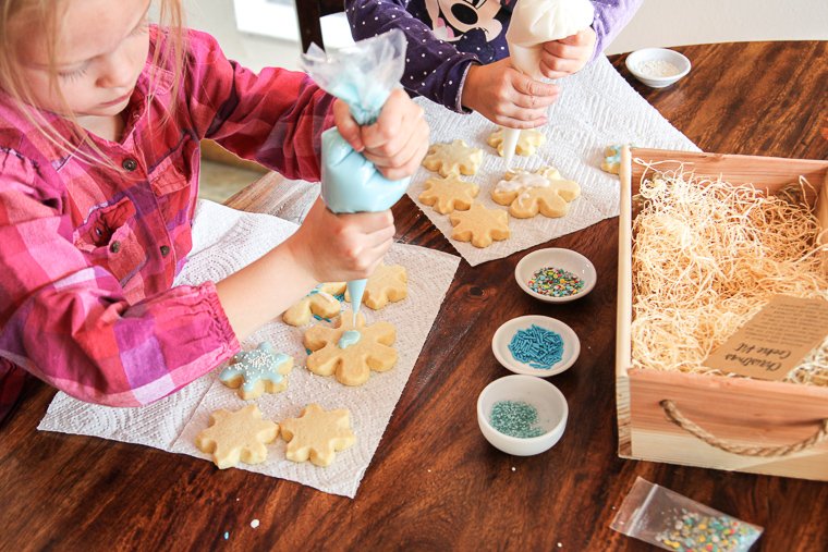 girls decorating the cookies from the kit