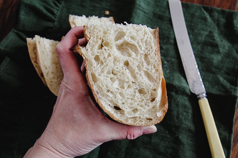 showing the open crumb of a loaf of sourdough bread
