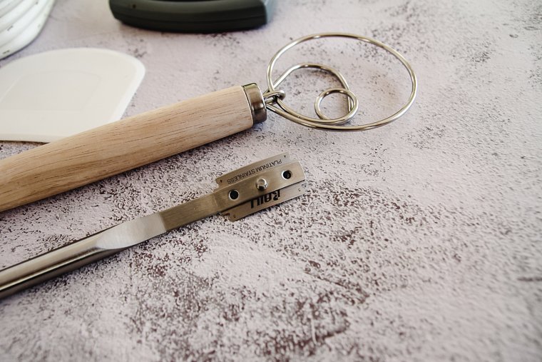 sourdough baking tools, specifically a lame and and Danish dough whisk