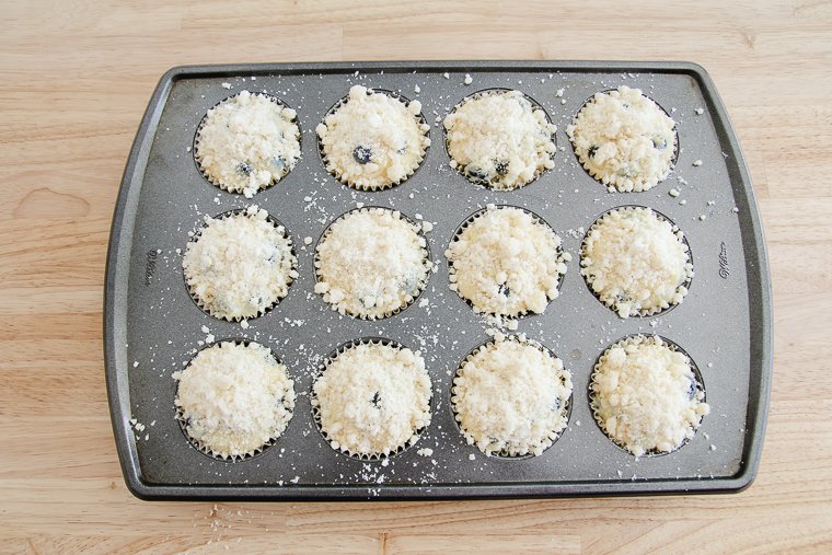 unbaked muffins after sprinkling with streusel topping
