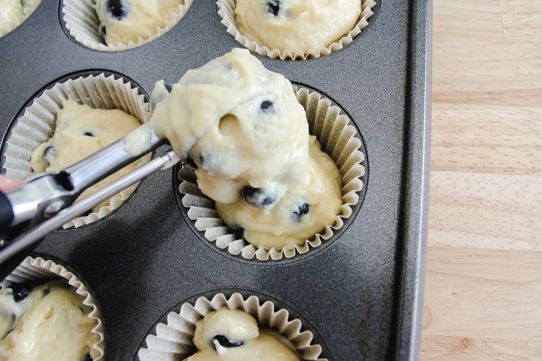 filling the muffin liners with batter