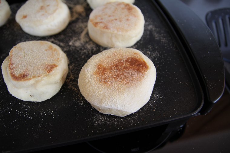sourdough english muffins browning on the griddle