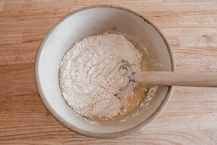 adding flour to the other ingredients