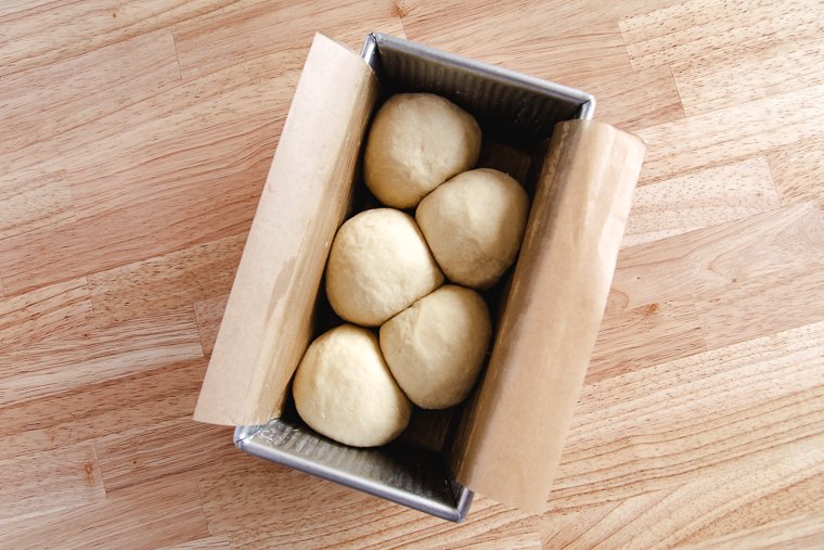 brioche dough before proofing: the dough balls do not fill the pan