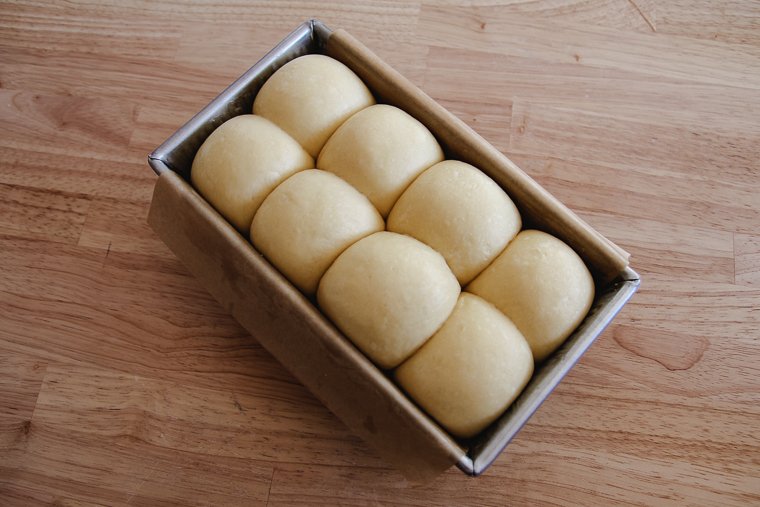 an alternate way to shape a brioche loaf: divide the dough into 8 balls and place them in the pan by twos