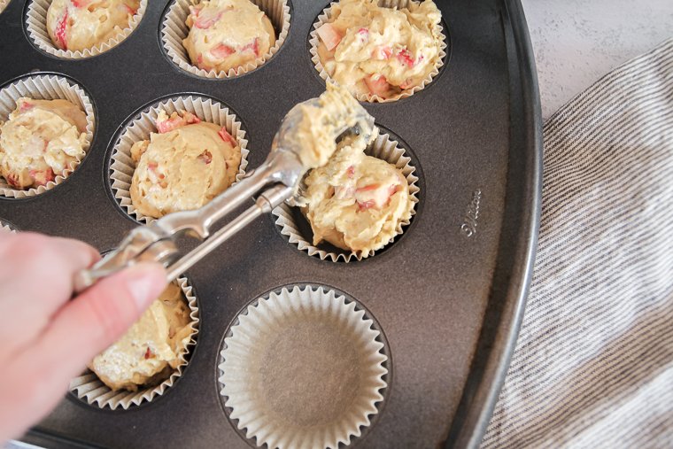 scooping the batter into the muffin tin