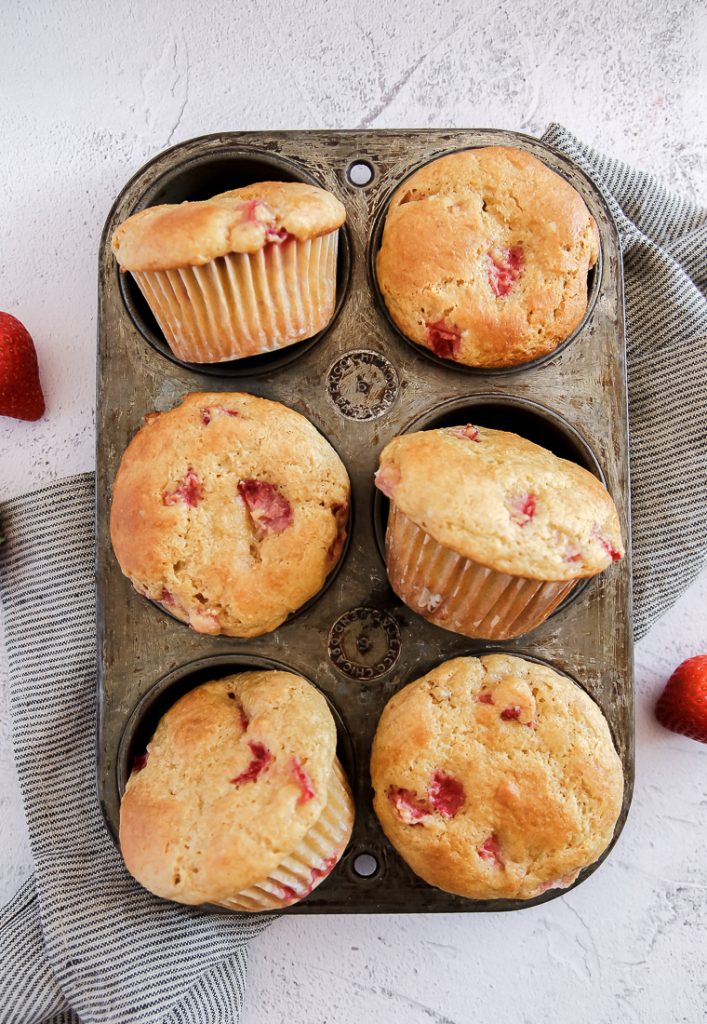 strawberry whole wheat and millet muffins in a muffin pan