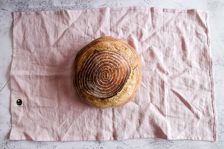 how to wrap round bread as a gift in a tea towel tied with twine for homemade bread gifts