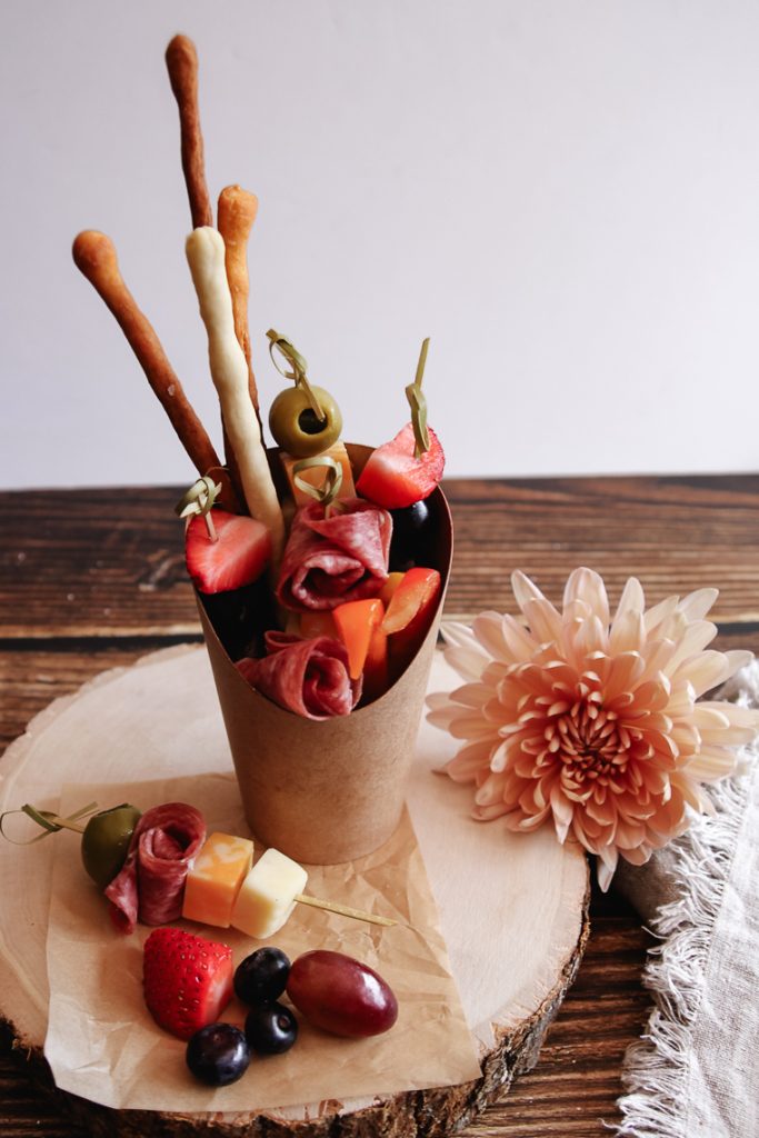 charcuterie cup next to a flower