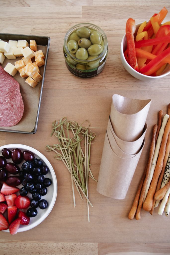 supplies and ingredients to make charcuterie appetizers in a cup