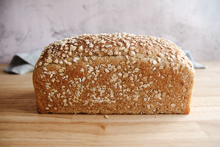 a side-view of a loaf of maple oat sourdough bread