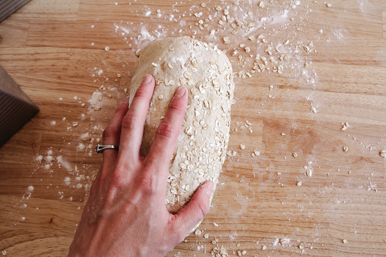 rolling the loaf through quick oats for a topping