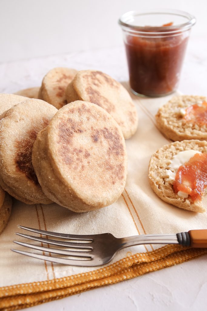 side view of whole wheat english muffins next to a fork