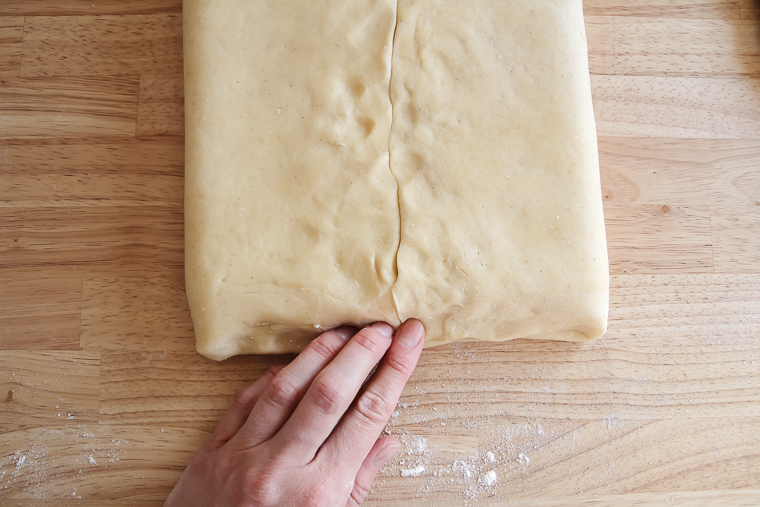 pinching/pressing the edges to seal the butter in