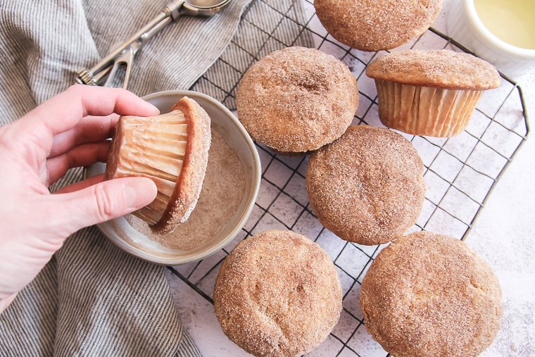 dipping the muffin in cinnamon-sugar