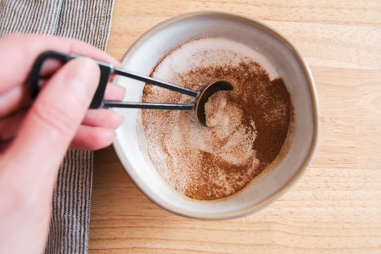 stirring cinnamon-sugar topping
