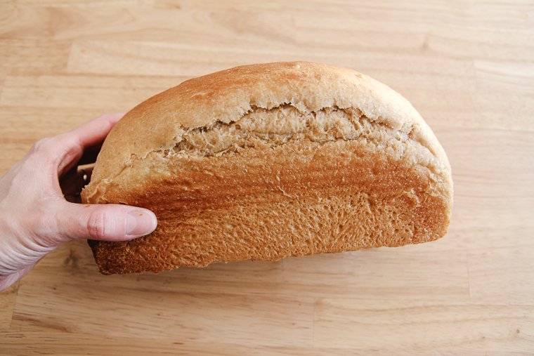 underproofed sandwich loaf that has tearing on the side