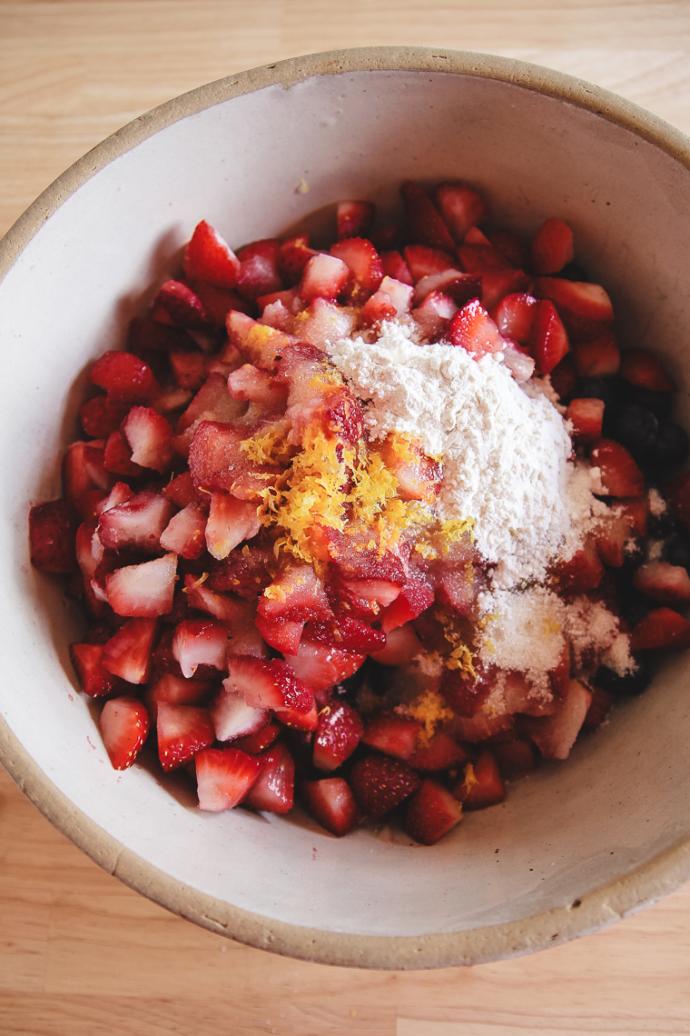 a stoneware bowl full of cut fruit with the filling ingredients