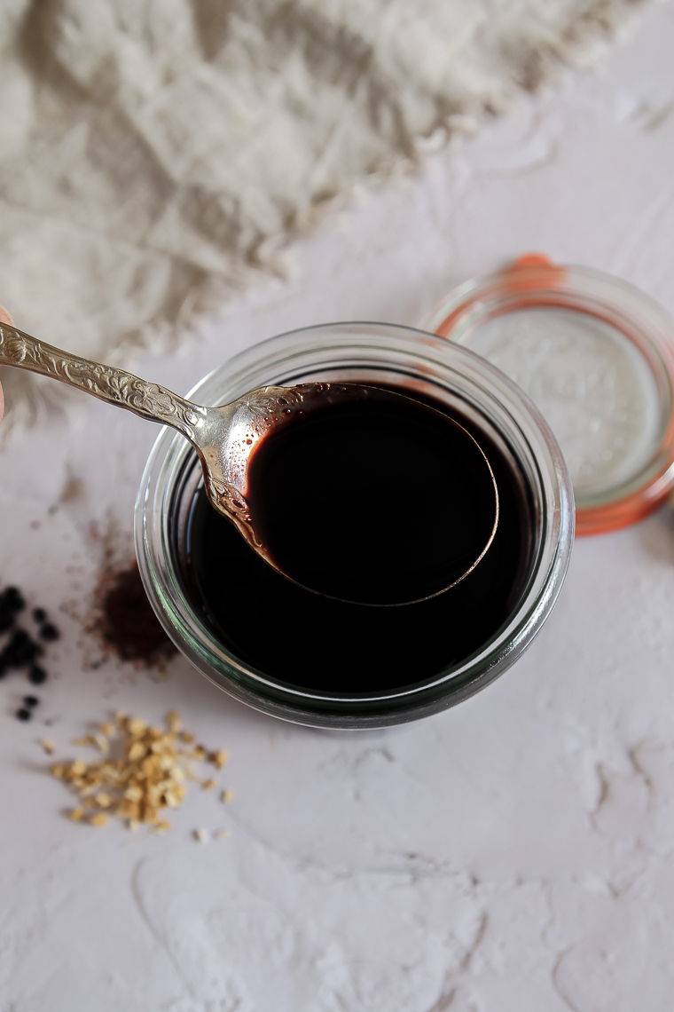 a spoonful of homemade elderberry syrup with rosehips and astragalus