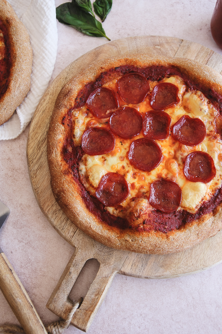 whole grain sourdough pizza on a serving board