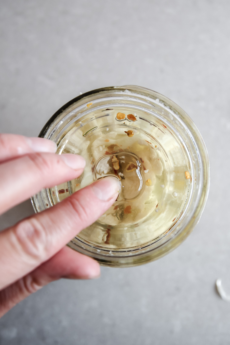 pressing a fermentation weight into the saltwater brine