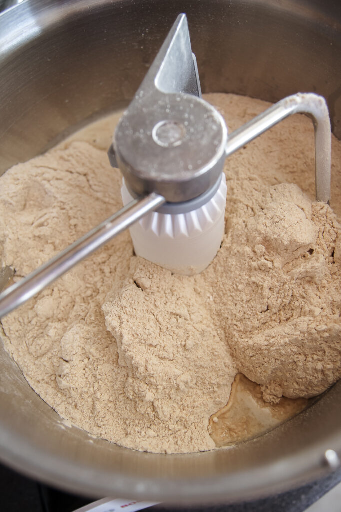 adding flour and water to Bosch mixer